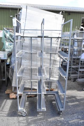 Metal double transport rack on commercial casters, featuring multiple shelves. Good condition, ideal for storage or transportation.