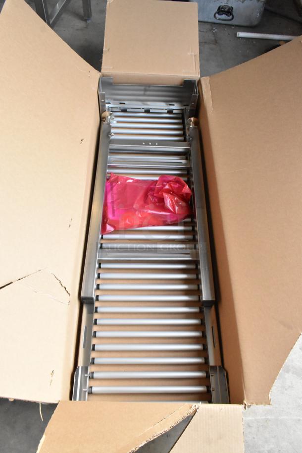 Hobart HRT5 stainless steel commercial roller conveyor wrapping station in new condition, shown in open cardboard box.