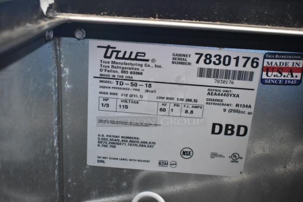 True TD-50-18 stainless steel commercial back bar cooler with two sliding lids, 115 volts, NSF certified label visible.