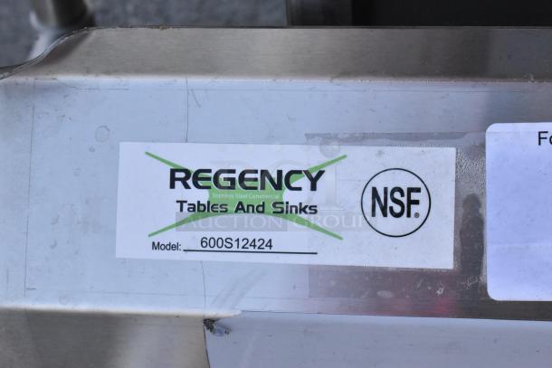 BRAND NEW Regency 600S12424 Stainless Steel Single Bay Sink, scratch and dent, no legs, NSF certified label visible.