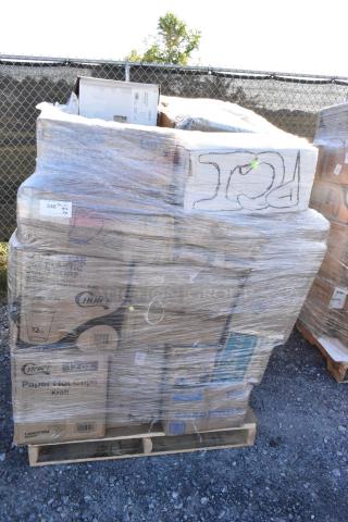 Shrink-wrapped pallet of assorted new scratch and dent items, including cold cups, towels, baking cups, on gravel surface.