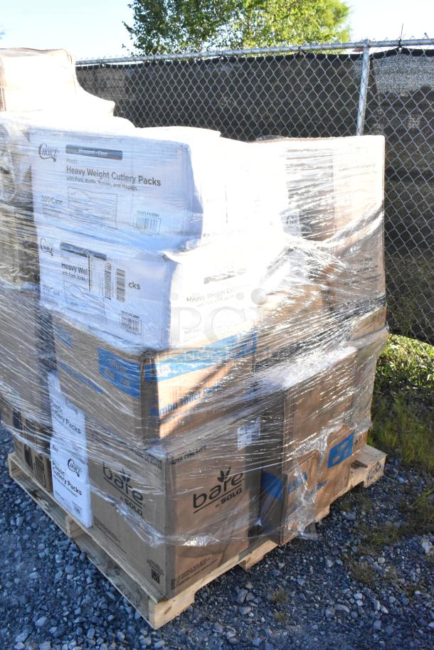 Pallet with boxes of brand new scratch and dent items, including toilet rolls, cone cups, t-shirt bags, plastic cutlery, food trays. Wrapped in plastic.