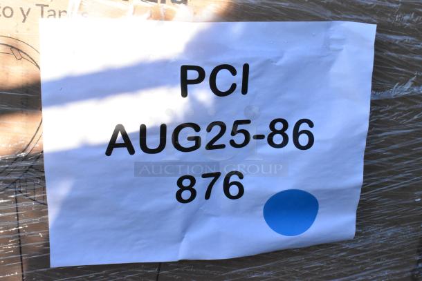 Auction items labeled "PCI AUG25-86 876" on a paper, some with minor scratches. Includes toilet rolls, bags, cutlery, etc.