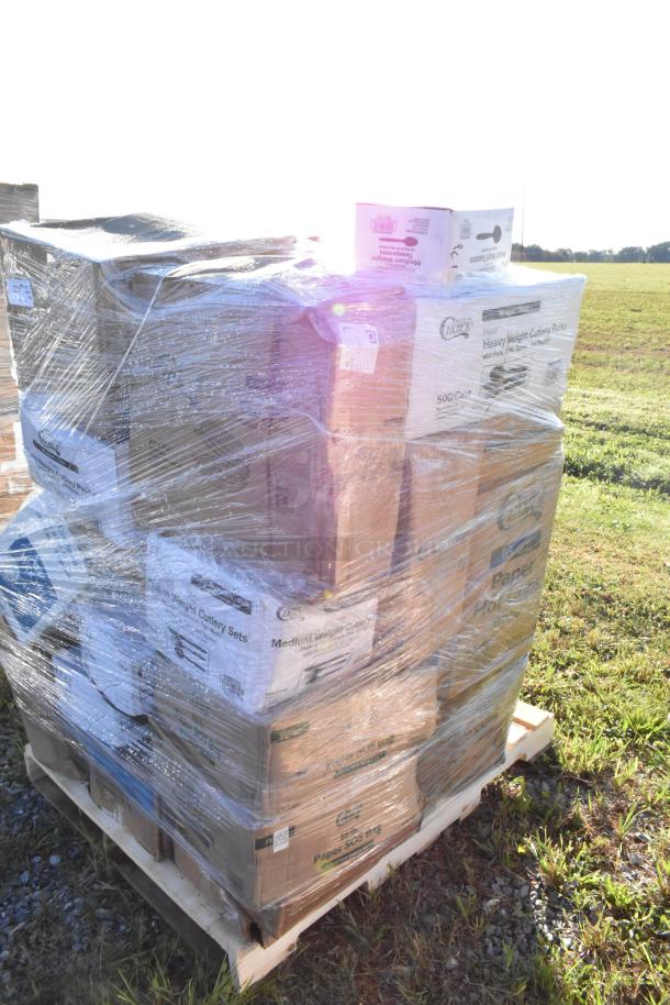 Pallet wrapped in plastic containing various scratch and dent items, including trash bags, paper bags, cutlery sets, and cups.