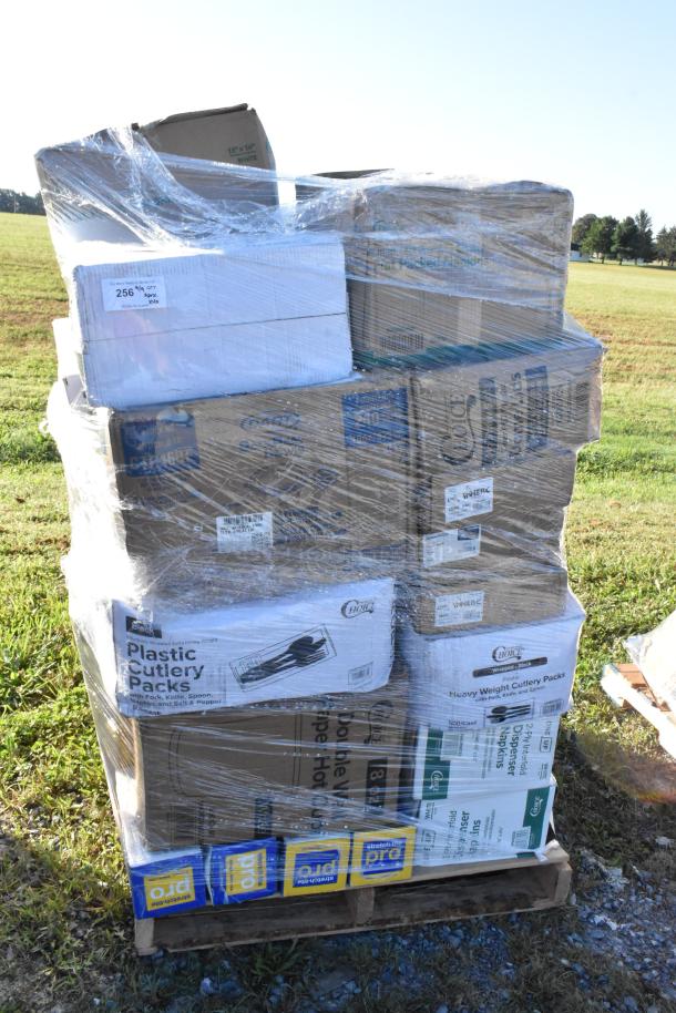 Pallet of 40 brand new scratch and dent items including napkins, paper plates, ice bags, sandwich wrap sheets, and paper towels, wrapped in plastic.
