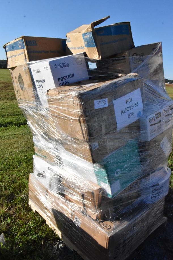 Plastic-wrapped pallet of assorted brand new scratch and dent items, including cups, containers, and trash bags. Labels visible.