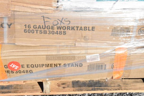 Stacked cardboard boxes labeled "16 Gauge Worktable" and "Equipment Stand" partially wrapped on a pallet.
