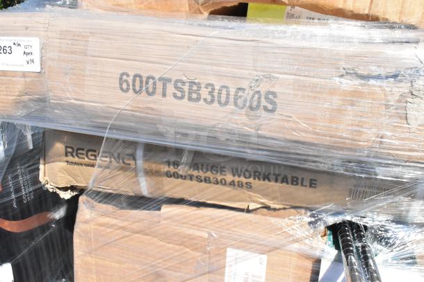 Branded boxes for 14 scratch and dent items, including Regency 16-gauge worktable, wrapped in plastic.