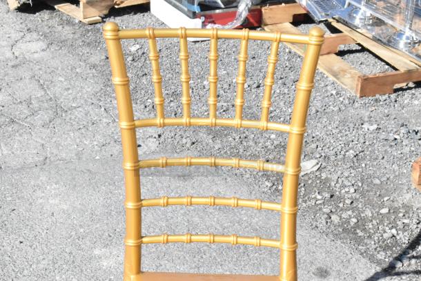 24 new Lancaster gold resin Chiavari chairs, scratch and dent condition. Elegant design, ideal for events.