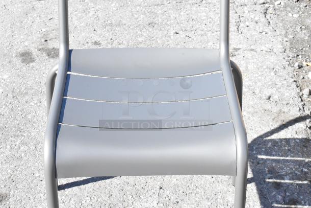 Matte gray powder-coated aluminum outdoor barstool by Lancaster Table & Seating, showing minor scratches, new condition.