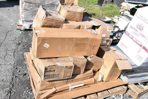 23 brand new scratch and dent items, including glasses and square mounts, in damaged boxes on a pallet. Various brands visible.