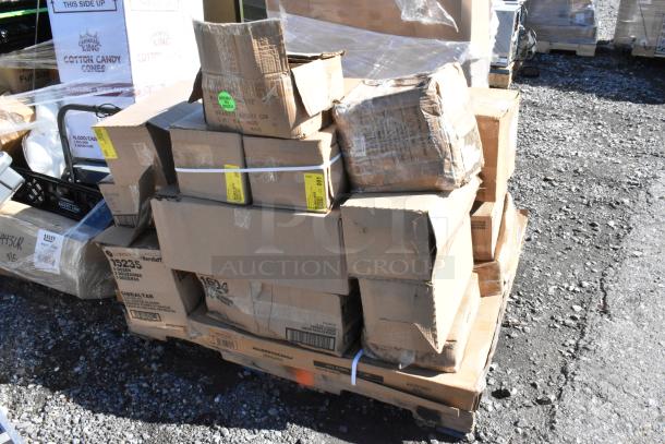 Stack of assorted boxes labeled "SCRATCH AND DENT," containing glasses and square mounts, on a pallet, outdoors.