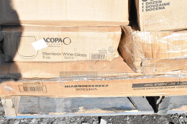 Boxes of Acopa 9 oz stemless wine glasses on pallet. Scratch and dent packaging. Contains 12 glasses per box.