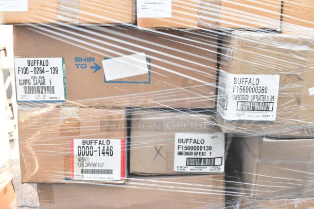 Stacked boxes labeled "Buffalo" containing new scratch and dent dishware, wrapped in plastic. Various plates and platters included.