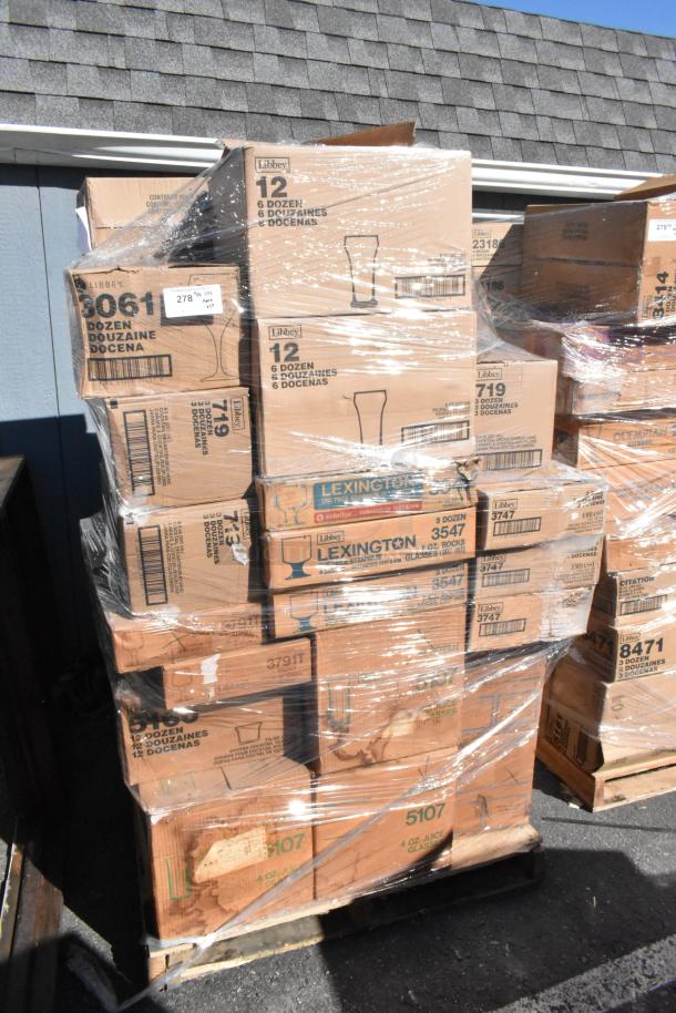 Pallet of boxed Libbey glassware, marked for auction, wrapped in plastic. Multiple boxes labeled by dozen count and type.