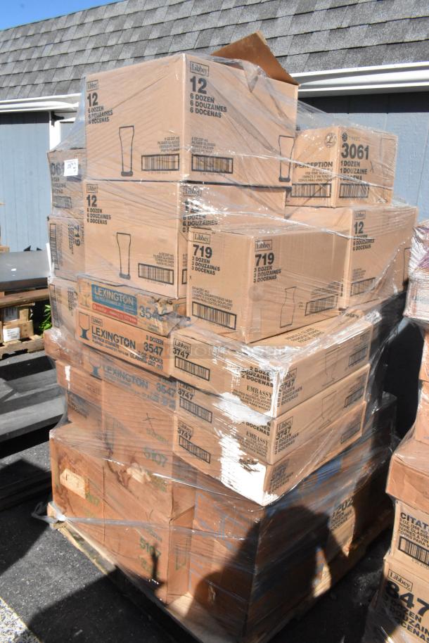 Stack of brand new "scratch and dent" boxed glassware, Libbey brand, various models, shrink-wrapped on a pallet.