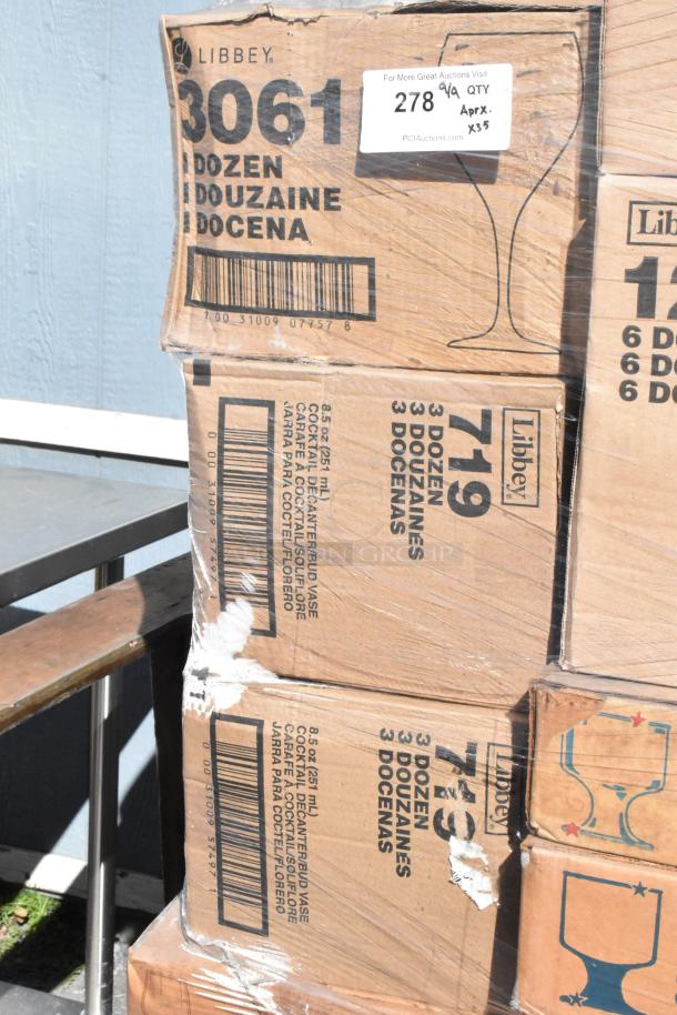 Cardboard boxes titled "Libbey" containing various glassware, marked "3061" and "719," each holding multiple dozens. Boxes appear scratched with visible labels.