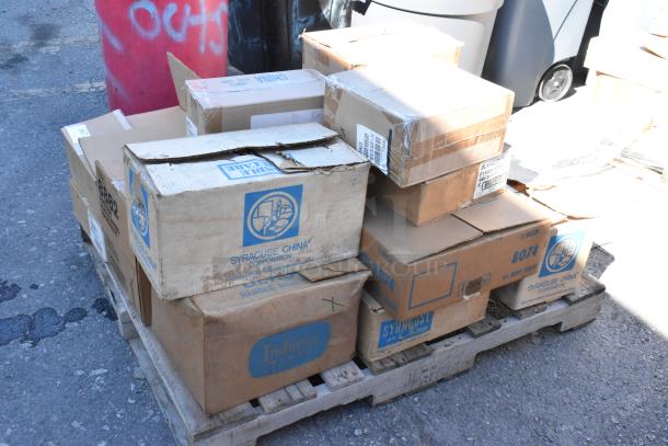 Boxes of dishware from Syracuse China on pallet; some are scratched and dented. 16 assorted brand new items inside.