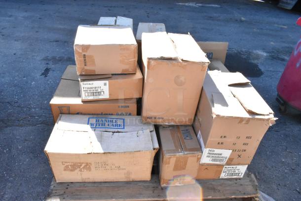 Boxes of brand new dishware with tags indicating "Made in China" and brands like Buffalo and Oneida, ready for auction.