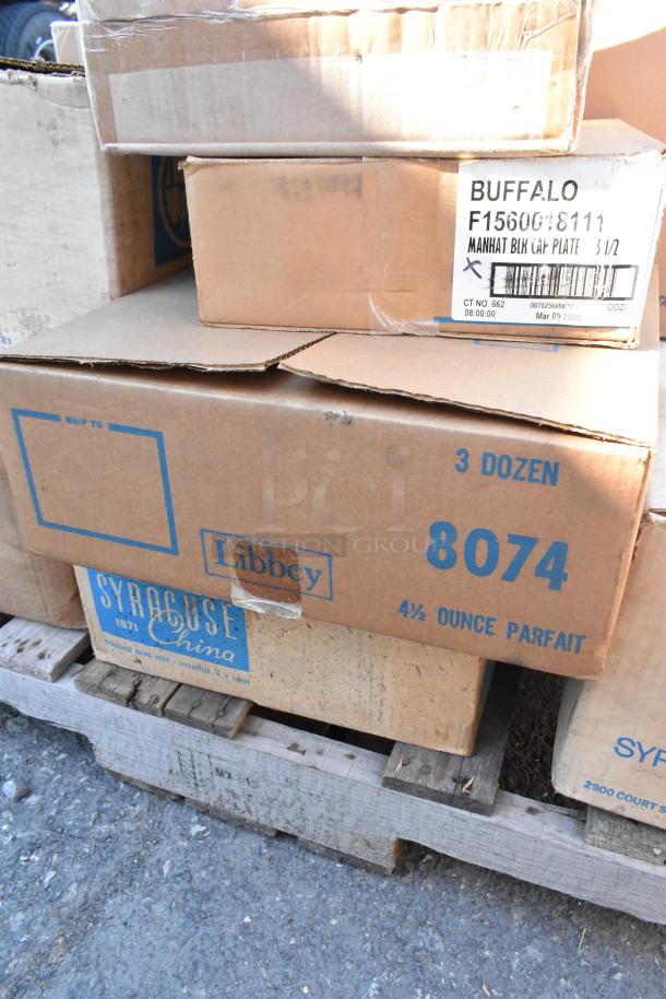 Boxes of dishware including Libbey parfait glasses and Buffalo plates, brand new with minor scratches and dents.