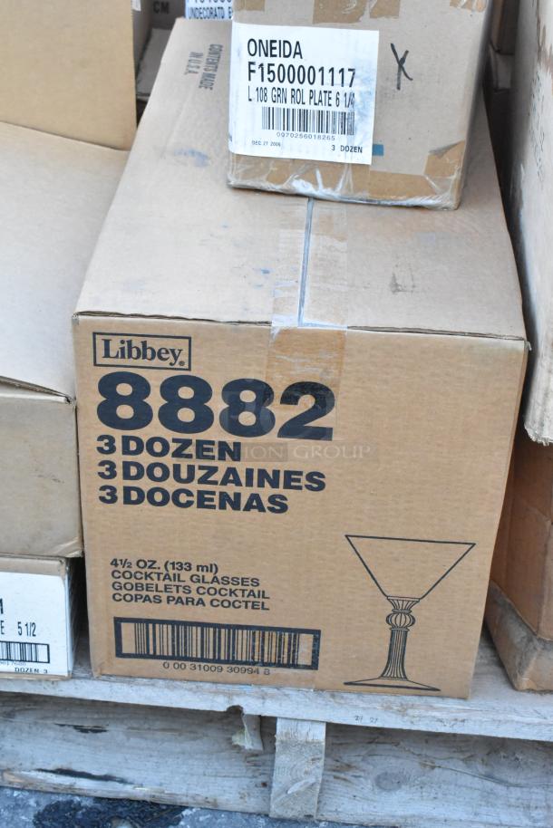 Boxes of Libbey and Oneida dishware on pallet, including 3 dozen Libbey cocktail glasses. Items are brand new, scratch and dent.