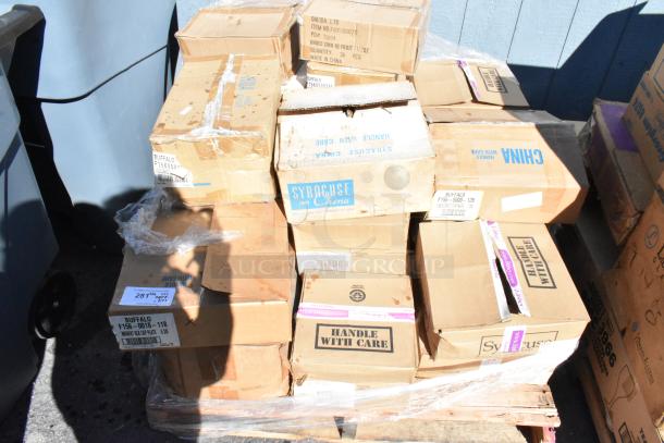 Boxes of various brand new scratch and dent dishware, labeled "Syracuse China" and "Handle With Care." Mixed condition.