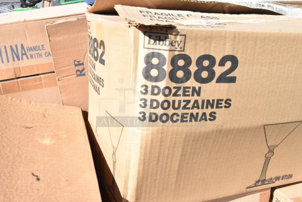 Cardboard box labeled "Libbey 8882" containing 3 dozen items, possibly glassware. Box shows signs of wear.