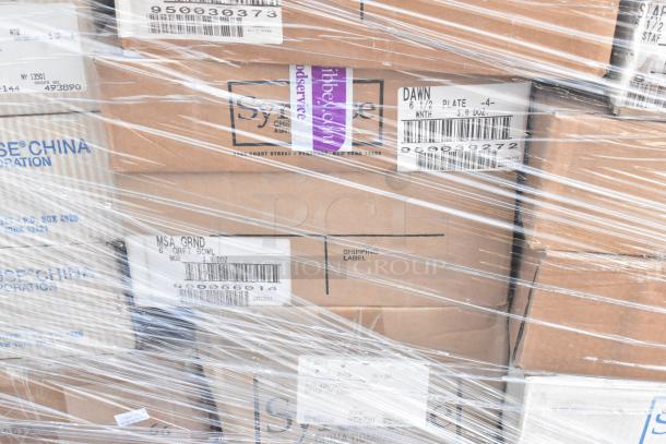 Plastic-wrapped boxes labeled with various dishware and glassware models, including "DAWN" plates and "MSA GRND" bowls.