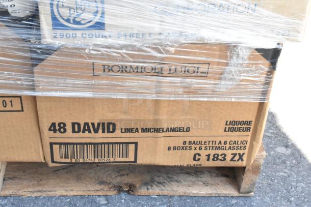Boxes of Bormioli Luigi stemglasses on a pallet, labeled "48 David Linea Michelangelo." Wrapped in plastic, new condition.