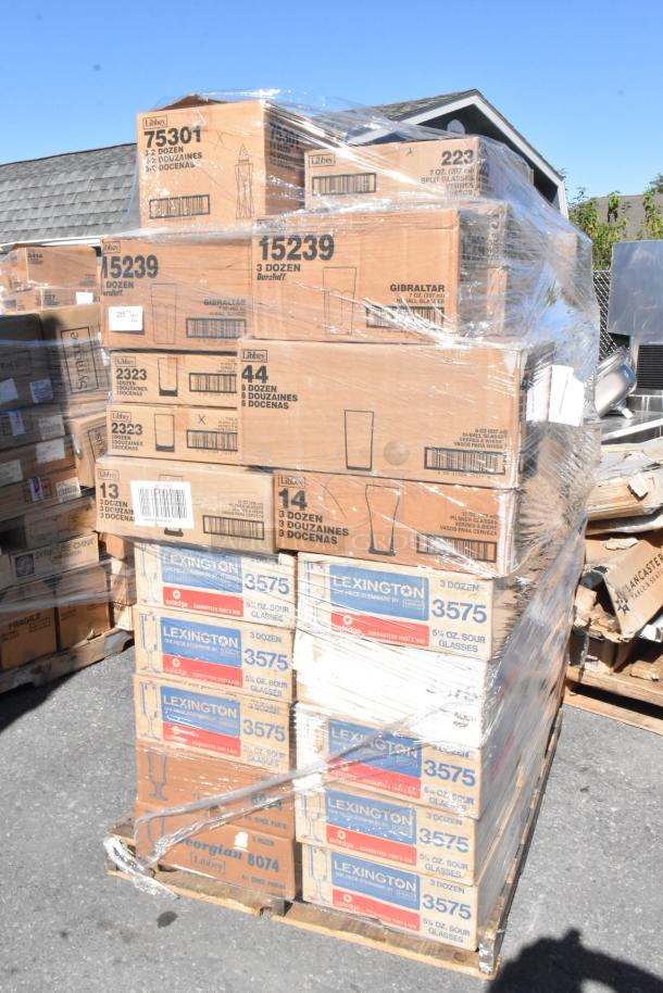 Pallet of boxes with glassware from brands Libbey and Lexington. Items are brand new, labeled as scratch and dent, wrapped in plastic.