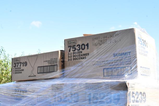 Libbey glassware boxes wrapped in plastic, labeled for martini glasses and salt shakers. New scratch and dent condition.