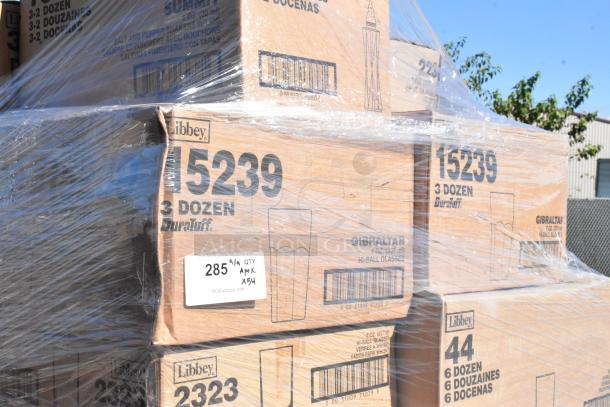 Pallet of Libbey glassware boxes, including Gibraltar Hi-Ball glasses, wrapped in clear plastic. New with scratch and dent. Quantity: 54.
