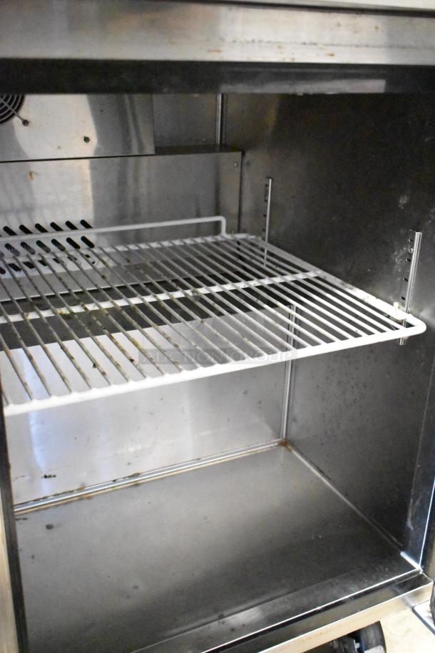 2017 Atosa MGF8402GR stainless steel commercial 2-door undercounter cooler on casters, interior view, shelving shown.