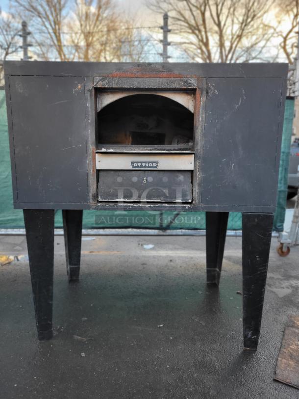 Attias Commercial Single Deck Pizza Oven, model “pizza oven,” black with visible wear, on metal legs.