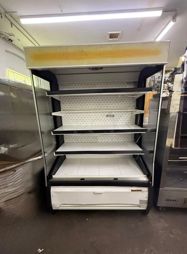 Universal Coolers Open Case Commercial Cooler with shelves, visible wear, and yellowing top panel. Ideal for retail displays.