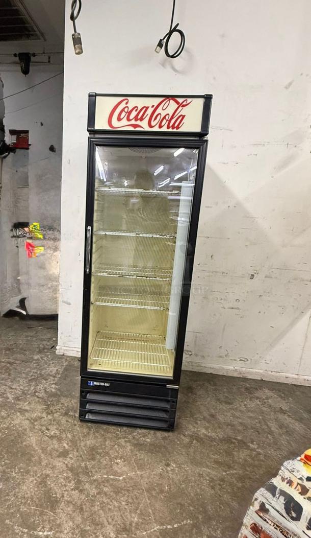 Master-Bilt Coca-Cola commercial cooler merchandiser with one glass door, featuring branded signage and interior shelves.