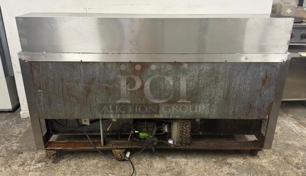 Leader Commercial 3-door undercounter lowboy refrigerator; stainless worktop; used condition with visible surface wear.