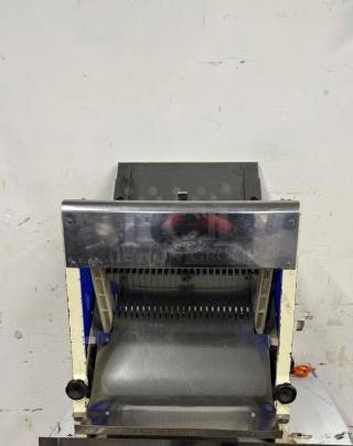 Omcan USA countertop bread slicer, model 302-5/18, 1/4 HP, 110V. Visible cutting blades, good condition.