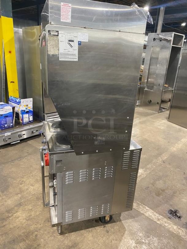 Wells VCS2000 ventless cooking system with stainless steel body, 4-French hot plate range, convection oven base, rear casters, and front legs.