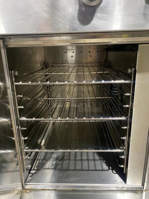 Wells VCS2000 stainless steel ventless cooking system with 4-French hot plate range, convection oven base, rear casters, front legs.