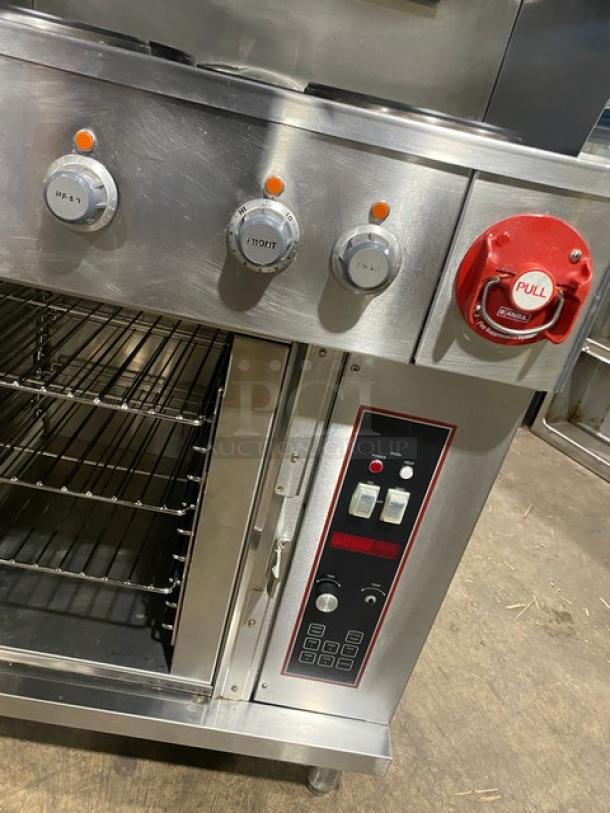 Wells VCS2000 stainless steel ventless cooking system with 4-French hot plate range, convection oven base, rear casters, front legs.
