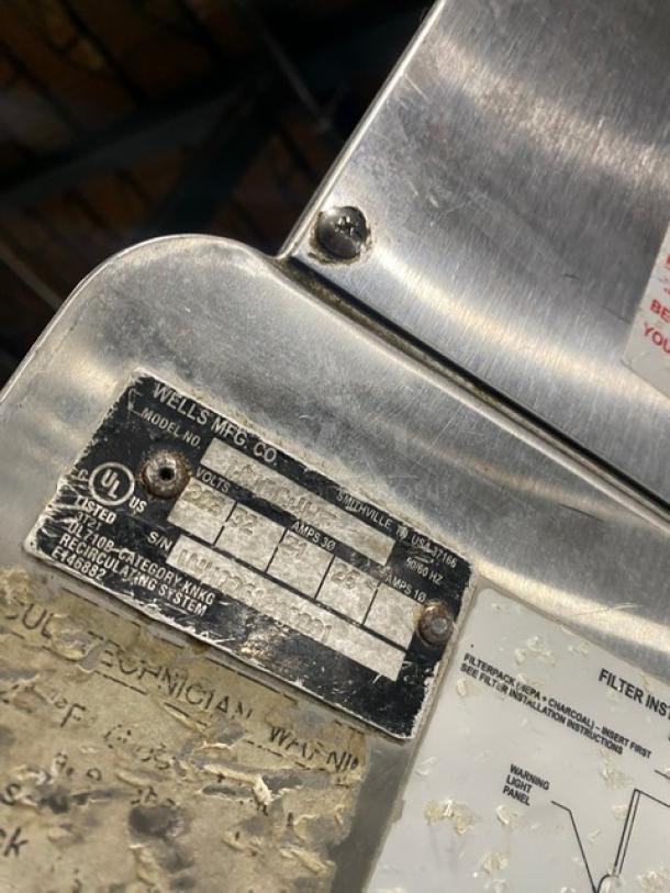 Wells VCS2000 ventless cooking system, stainless steel, featuring a 4-French hot plate range and convection oven base, rear casters, front legs. UL listed label visible.