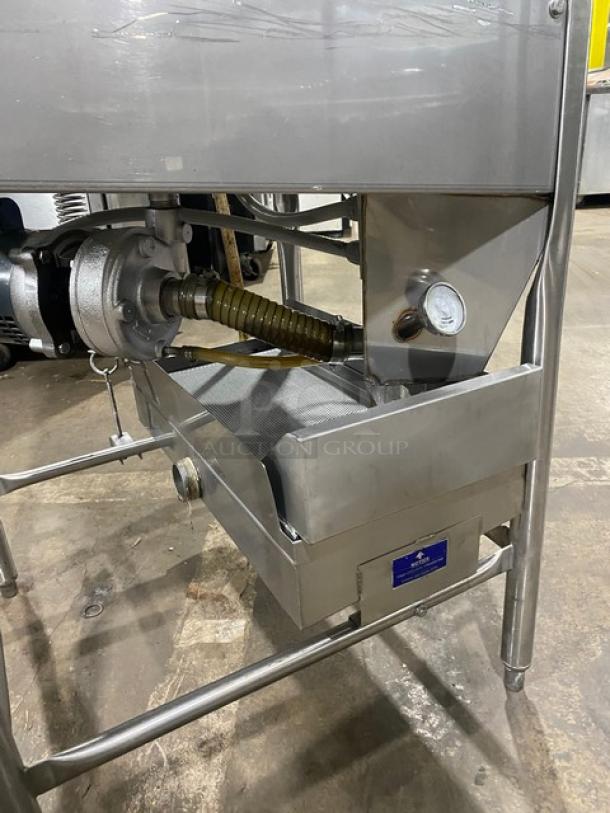 Stainless steel dishwasher, model ES2000, on legs. Energy Star Certified. Visible pressure gauge and hose attachment.