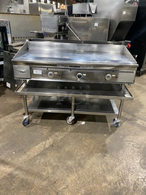 Keating stainless steel natural gas countertop flat griddle, model 60X30, with back and side splash, undershelf stand, on casters.