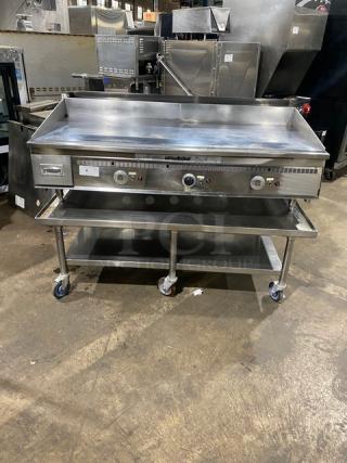Keating stainless steel natural gas countertop flat griddle, model 60X30, with back and side splash, undershelf stand, on casters.