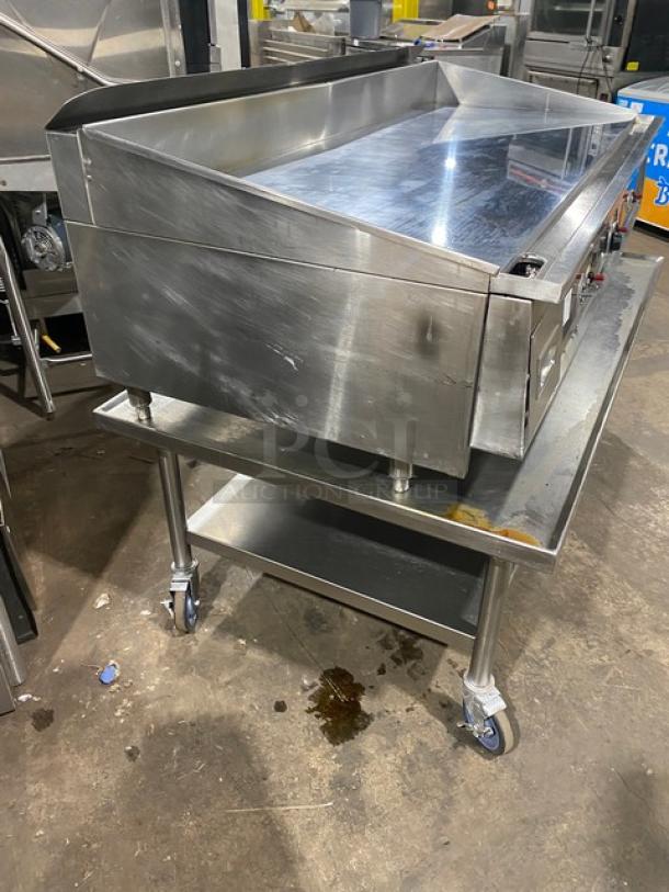 Keating 60X30 stainless steel natural gas tabletop griddle, with back and side splash, on caster stand, model GG47746.