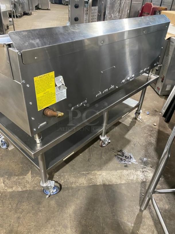 Keating stainless steel natural gas countertop griddle, model 60X30, on casters with undershelf stand. Equipped with back and side splash.