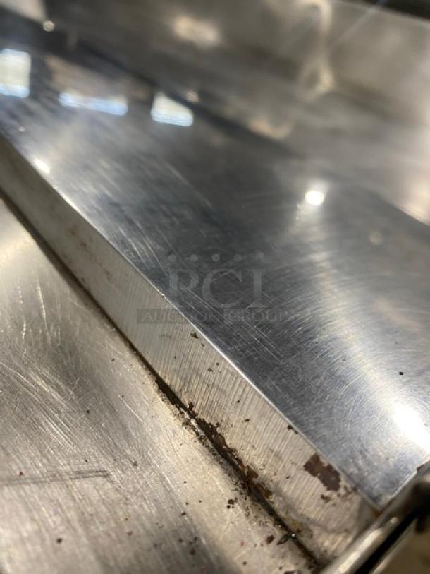Keating stainless steel natural gas flat griddle, model 60X30, with back and side splash, undershelf stand, on casters.