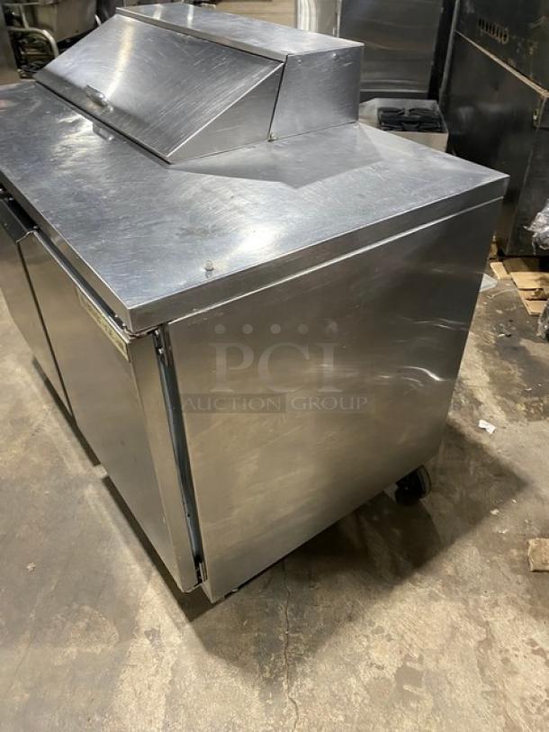 Beverage-Air SPE48HC-08 stainless steel 2-door refrigerated prep table with poly-coated wire racks, on casters, shown in good condition.