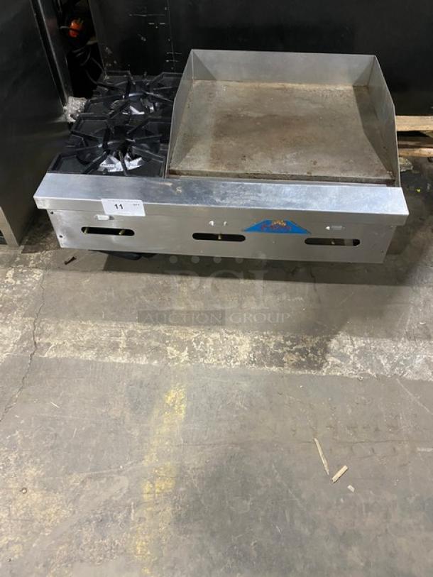 Comstock Castle stainless steel 2-burner griddle range, model FHP36-24, with back & side splash, on legs, natural gas powered.